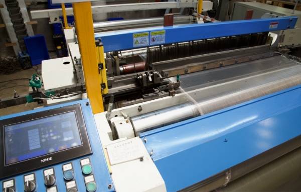 The advanced CNC weaving machine is operating for industrial wire cloth production.
