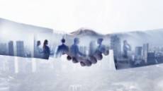 Two businessmen are looking at the sky.