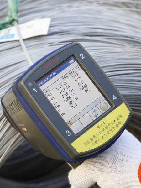 A hand-held positive material identification gun is used to test raw material component.