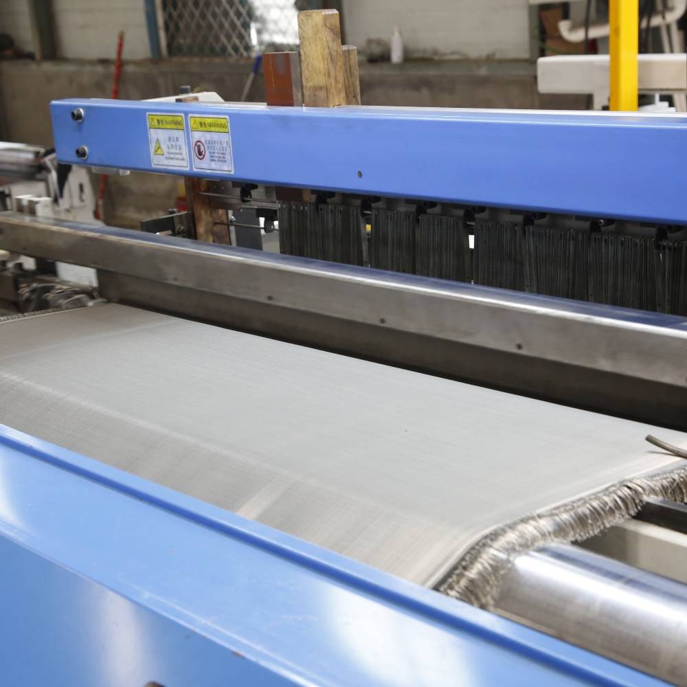 The weaving machine is weaving stainless steel wire cloth.
